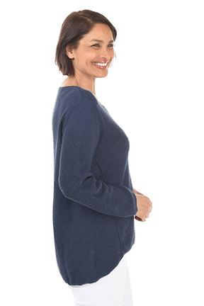 Woman wearing a navy blue sweater on a white background