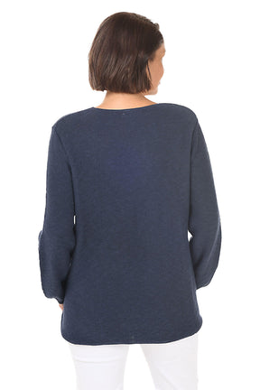 Woman wearing a navy blue sweater on a white background