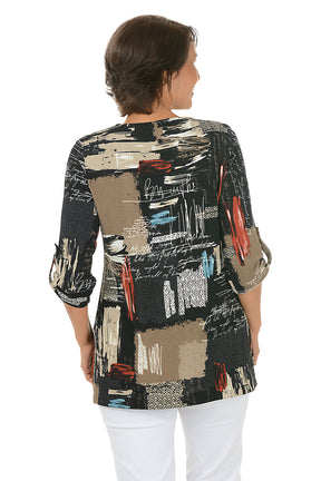 Woman wearing a colorful patterned blouse with white pants on a white background. Back shot.