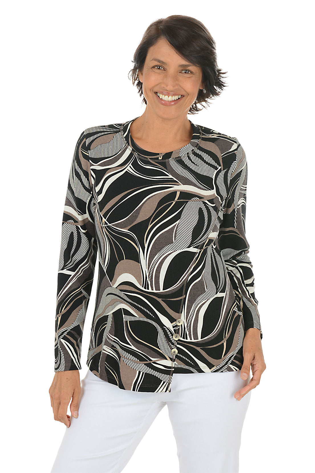 Woman wearing a patterned long-sleeve top and white pants on a white background.