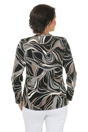 Woman wearing a patterned long-sleeve top and white pants on a white background. Back shot.