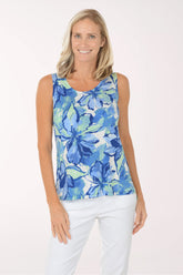 Woman wearing a blue floral sleeveless top against a white background