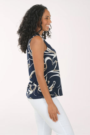 Woman wearing a sleeveless top with a blue and white abstract pattern on a white background