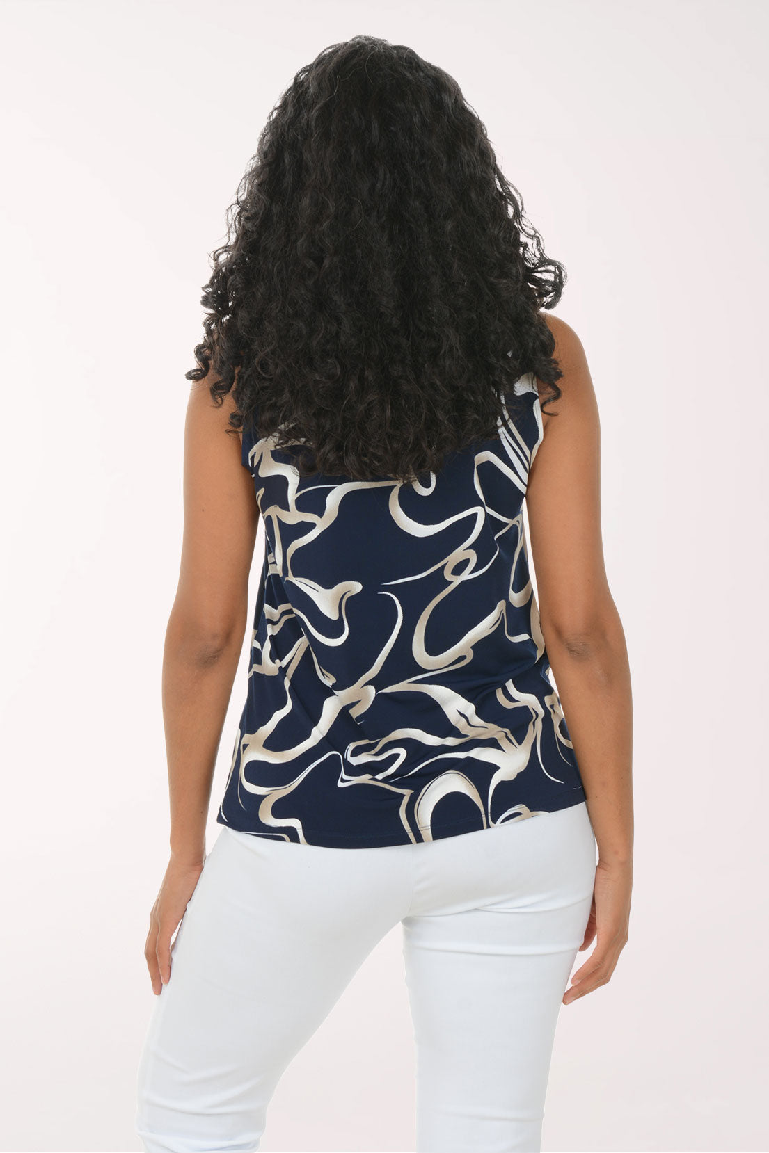 Woman wearing a sleeveless top with a blue and white abstract pattern on a white background