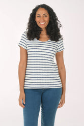 Woman wearing a striped shirt and blue jeans on a white background