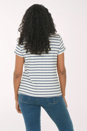 Woman wearing a striped shirt and blue jeans on a white background