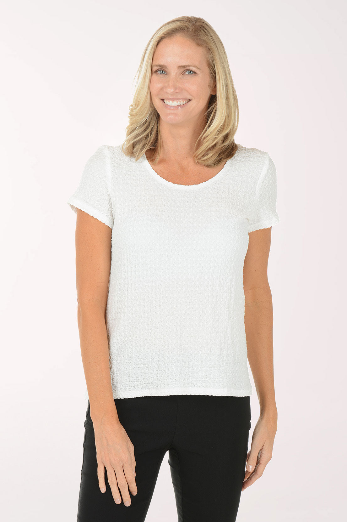 Woman wearing a white t-shirt and black pants on a white background