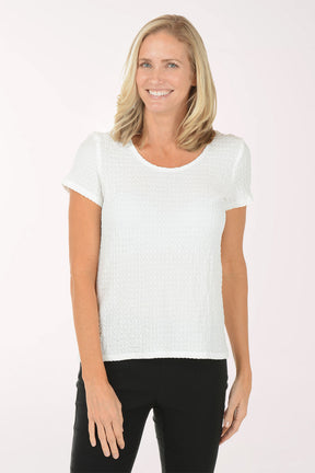 Woman wearing a white t-shirt and black pants on a white background