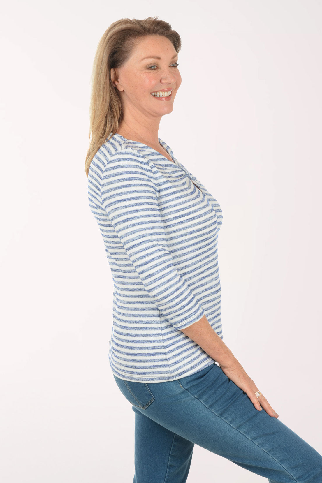 Woman wearing a blue and white striped shirt with a white background