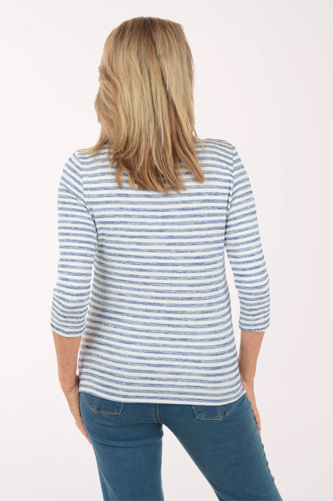 Woman wearing a blue and white striped shirt with a white background
