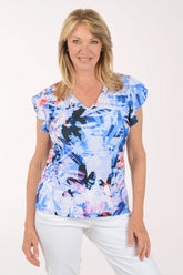 Woman wearing a colorful butterfly-patterned top on a white background