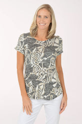 Woman wearing a patterned top on a white background