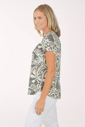 Woman wearing a patterned top on a white background