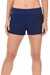 A pair of navy blue stretch woven beach shorts with built-in brief, front zip pockets, and side slits on the hemline. The shorts are fully lined and have a mid-waist rise.