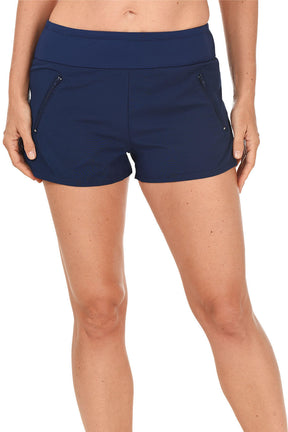 Navy blue swim shorts worn by a person on a white background.