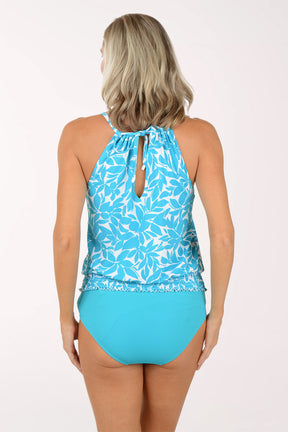 Woman wearing a blue floral tankini set on a white background