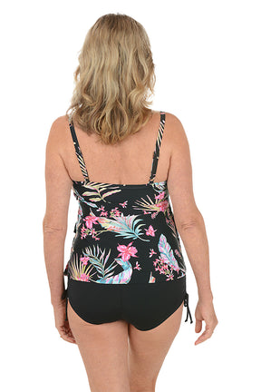A woman wearing a black tankini swim top with a three tiered design. Back shot.