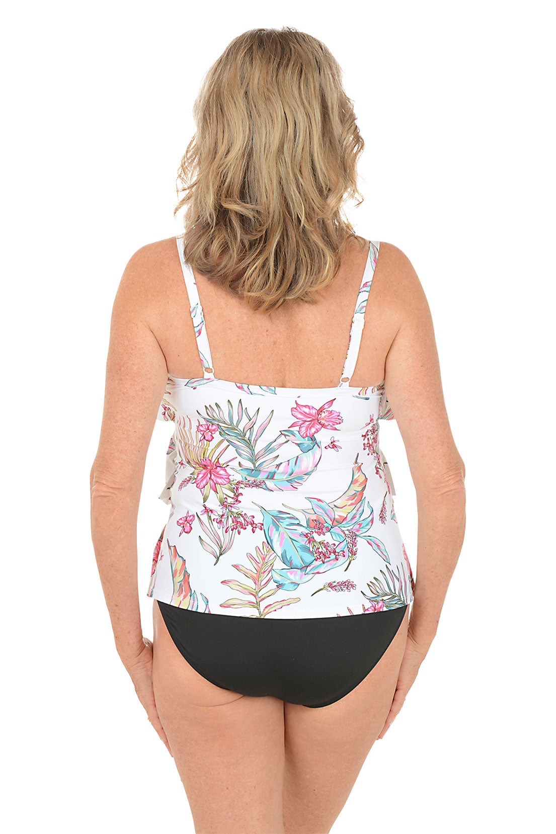 Woman wearing a floral tankini top and black bottoms on a white background. Back shot.