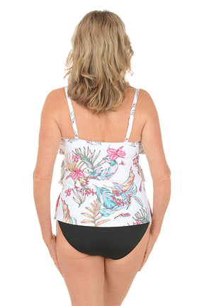 Woman wearing a floral tankini top and black bottoms on a white background. Back shot.