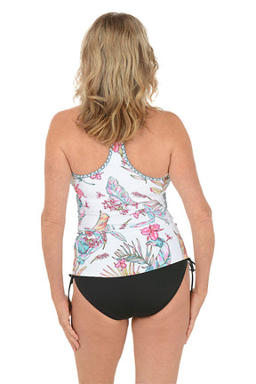 Woman wearing a tropical print tankini set on a white background. Back shot.