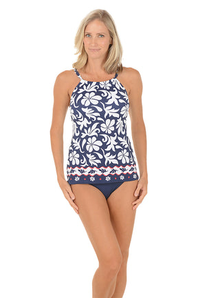 A woman wearing a navy and white tropical print tankini swim top. Full front shot.