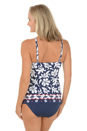 A woman wearing a navy and white tropical print tankini swim top. Back shot.