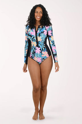 Woman wearing a colorful floral swimsuit with long sleeves on a white background