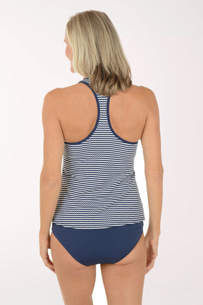 Woman wearing a navy and white striped tankini set on a white background. Back shot.