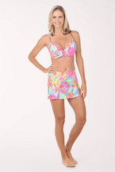 Woman wearing  a colorful matching bikini top and swim skirt.