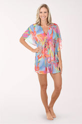 Woman wearing a colorful tie-dye cover-up on a white background