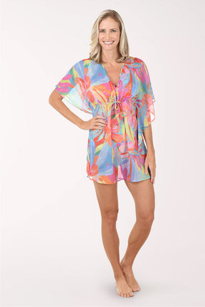 Woman wearing a colorful tie-dye cover-up on a white background