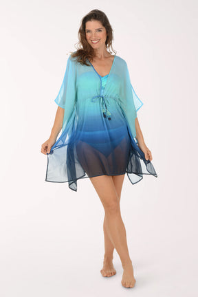 Woman wearing a blue and green gradient cover-up dress on a white background.
