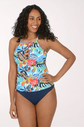 Woman wearing a colorful floral tankini set on a white background