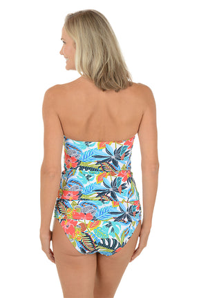 A woman wearing a multicolored swim tankini top with a twist front on the bust. Back shot.