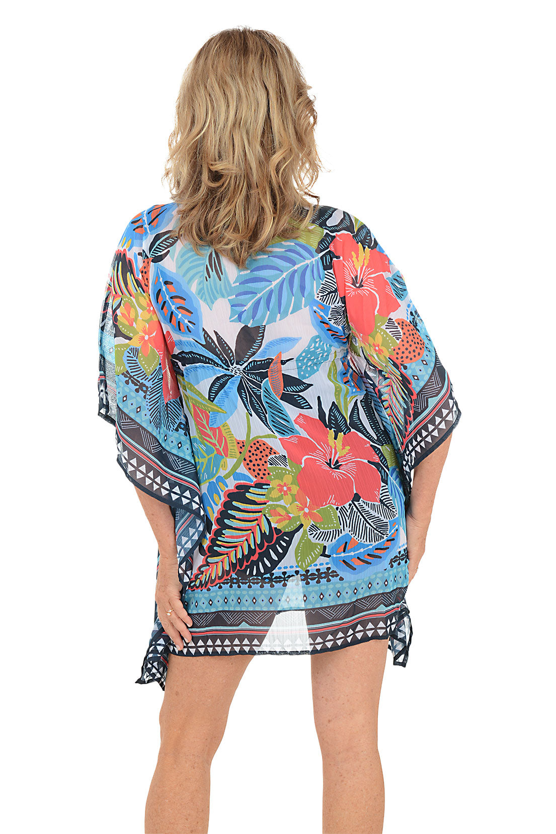 A woman wearing a multicolored floral pattern caftan. Back shot.