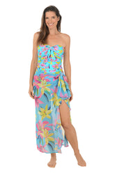 Woman wearing a colorful strapless cover-up with floral pattern on a white background