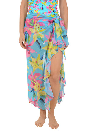 Woman wearing a colorful floral skirt on a white background