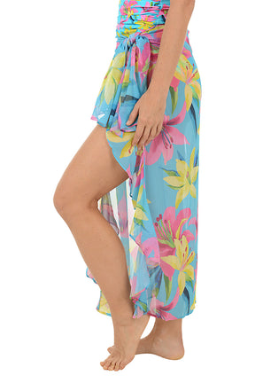 Woman wearing a colorful floral skirt on a white background