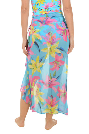 Woman wearing a colorful floral skirt on a white background