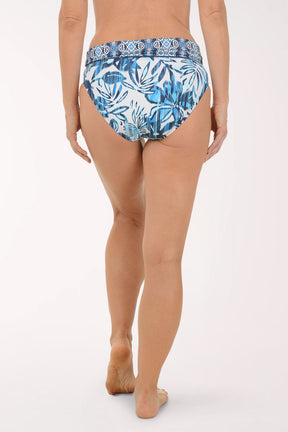Person wearing blue patterned underwear on a white background. Back shot.