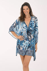 Woman wearing a blue and white patterned kimono-style garment on a white background