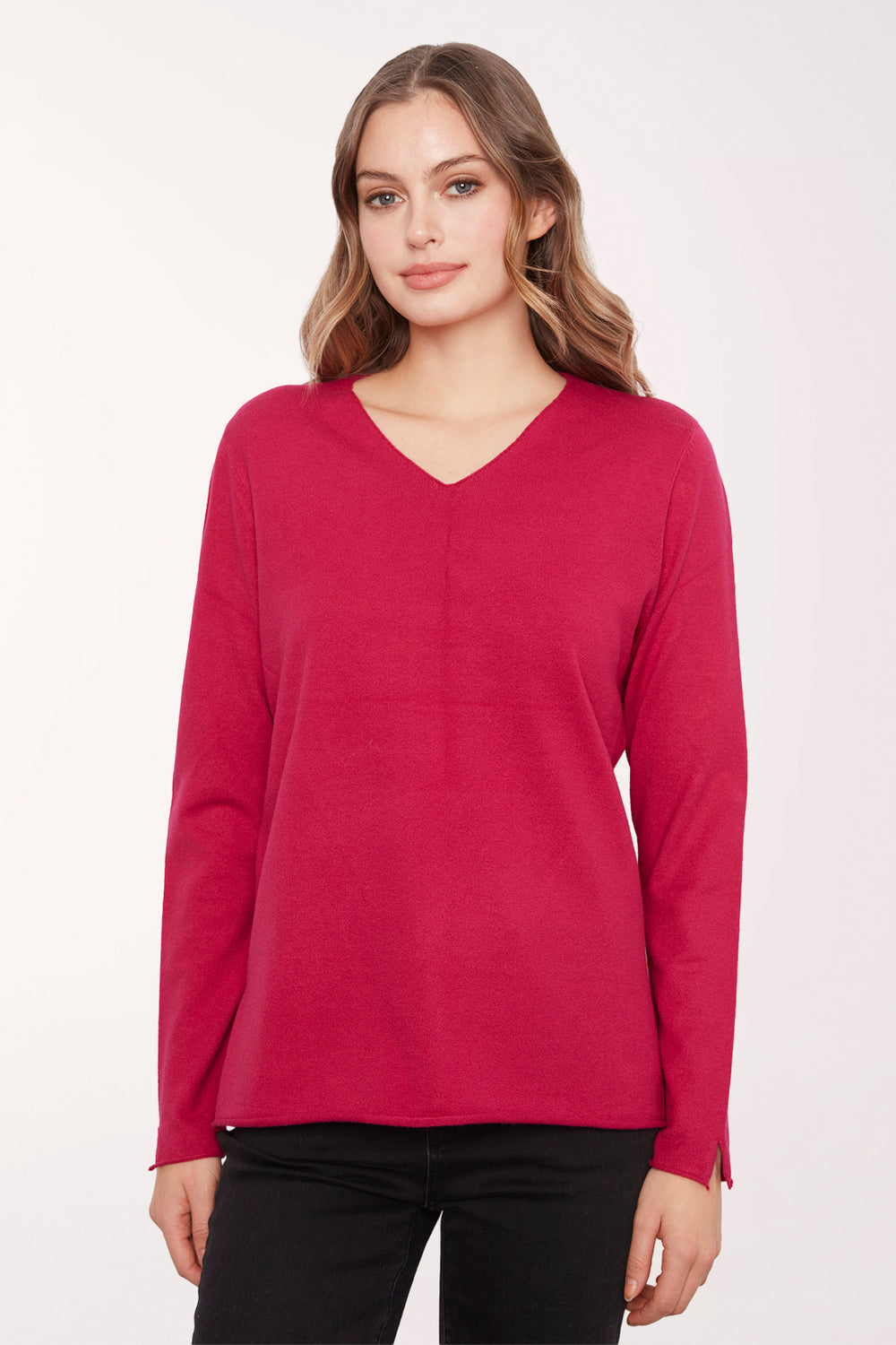 Woman wearing a solid red v-neck long sleeve sweater 