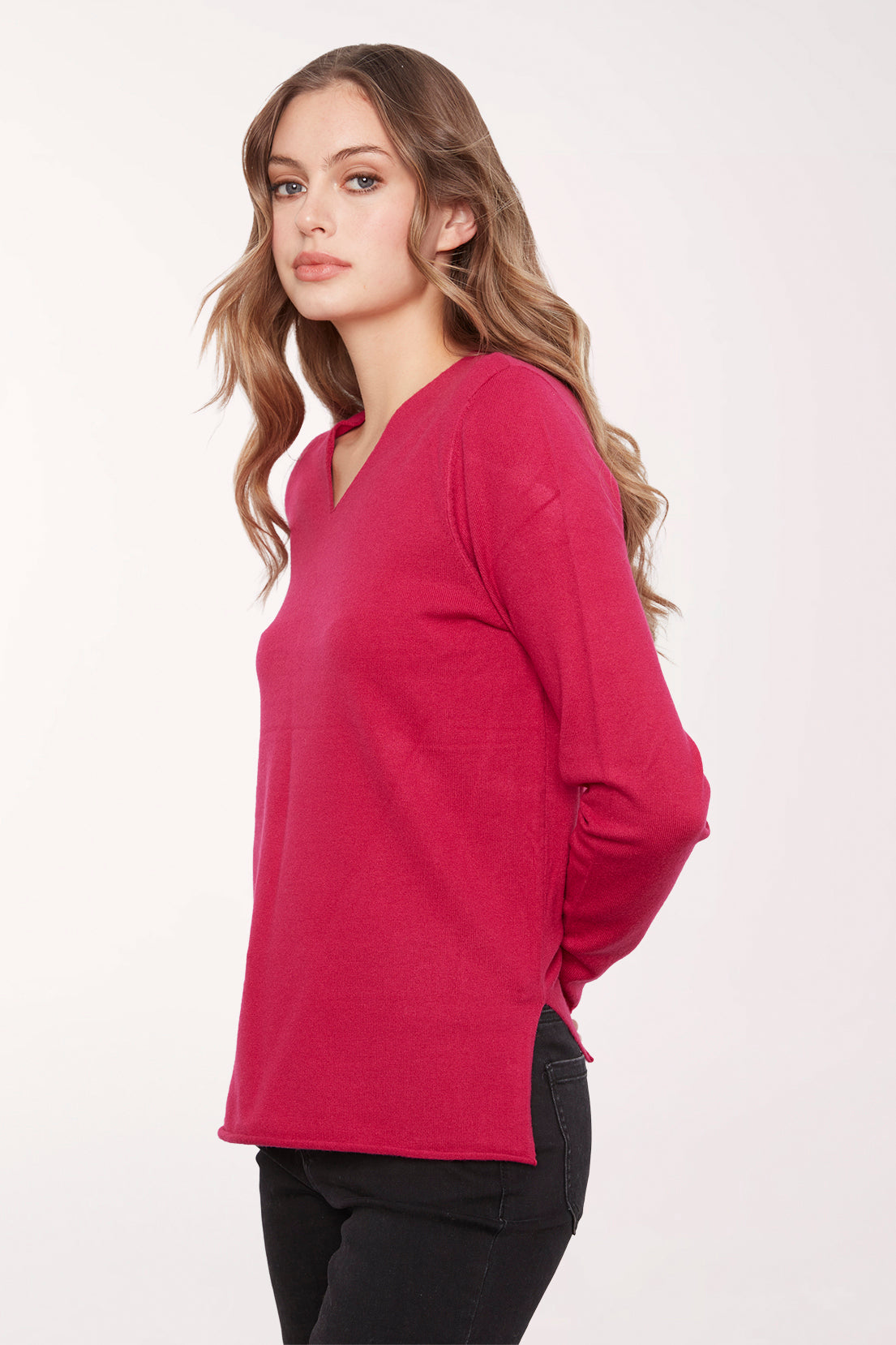 Woman wearing a solid red v-neck long sleeve sweater 