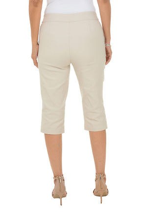 Beige capri pants worn by a person on a white background. Back shot.