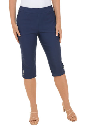 Navy blue capri pants worn by a person on a white background