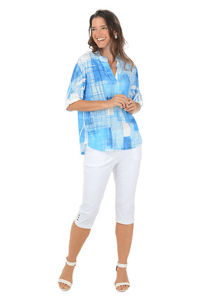 A woman wearing white cropped capri pants. Full length shot.