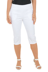 A woman wearing white cropped capri pants.