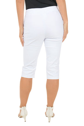 A woman wearing white cropped capri pants. Back shot.