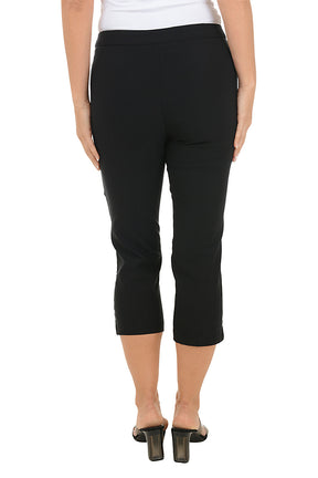 A woman wearing black capri pants. Back shot.