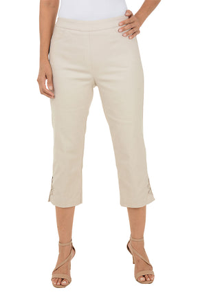 A woman wearing beige capri pants.